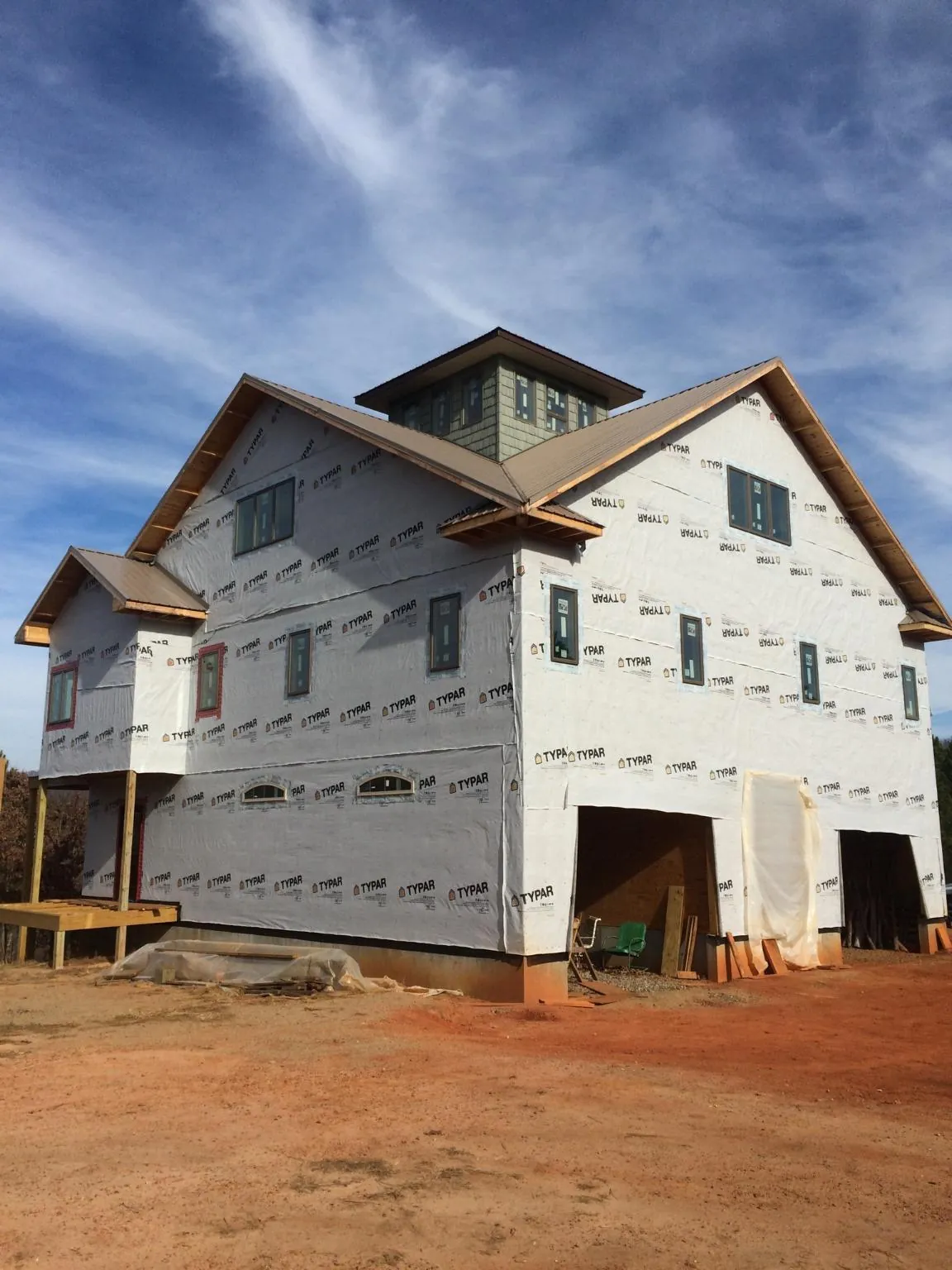 New two story house under construction with a cupola and gabled roofs in Harpster